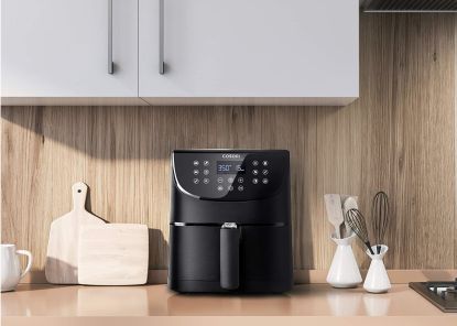 COSORI Air Fryer Max XL on a kitchen worktop with wood cabinetry